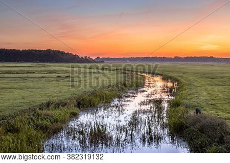 Sunset Landscape Of Lowland River Koningsdiep In The Netherlands