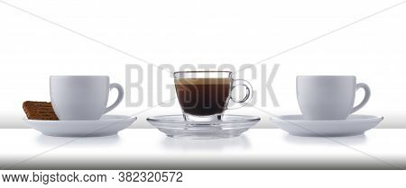 A Row Of 3 Glass And White Expresso Cups And Saucers Full Of Smooth Expresso Coffee, On A White Styl