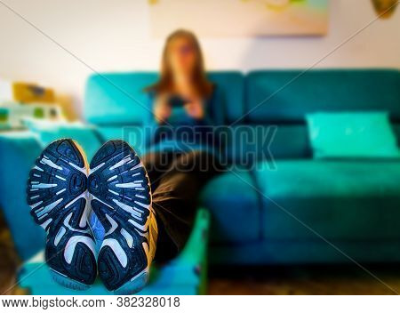 Close Up Of Shoes Of A Woman Sitting On The Couch In The Living Room