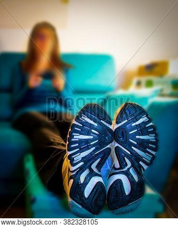 Close Up Of Shoes Of A Woman Sitting On The Couch In The Living Room
