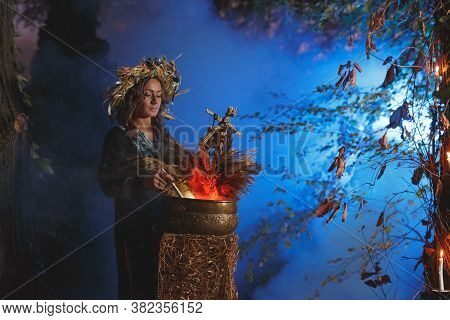 A Forest Witch Brews A Potion Holding A Voodoo Doll.