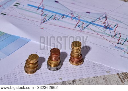 Investment Money Concept. Stacks Of Coins Of Different Heights Symbolizes Economic Growth. Three Sta