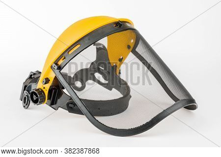 Yellow Construction Mask-grid On A Wooden Table On A White Background