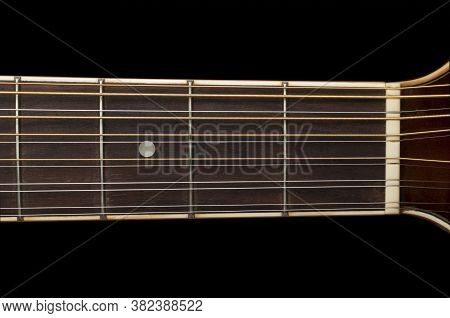 Detail Of A 12 String Guitar Fretboard On Black Background