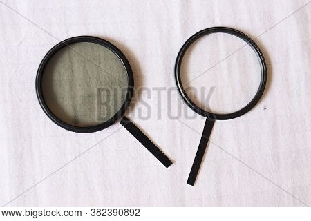 Two Magnifying Glasses With White Background. Black And White Magnifying Glass. Dark And Bright Side