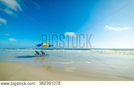Beach Chairs And Parasol In World Famous Daytona Beach. Florida, Usa