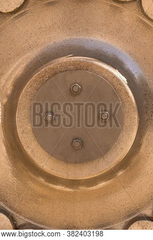 Large Iron Mechanism With Bolted Nuts And Bolts. Round Metal Engineering Structure