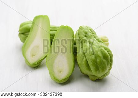 Chayote Squash Or Mirlition Squash On White Table, Organic Vegetable, Edible Plant Fruit