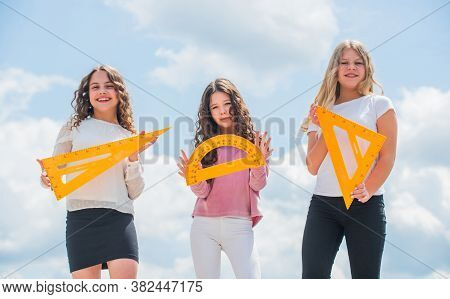 Education Concept. School Students Learning Geometry. Girls With Triangle Ruler. Smart Friends. Scho