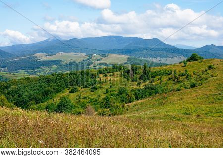 Carpathian Countryside In September. Mountain Landscape On A Sunny Day. Trees On The Meadow. Sky Wit