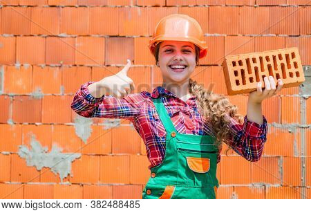 Little Worker In Helmet Building From Brick. Architecture Construction Child. Child In Uniform Worki