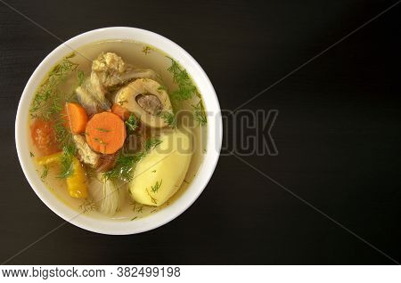 Shurpa Soup In A White Bowl On Dark Wooden Background With Copy Space. Top View. Famous Traditional 