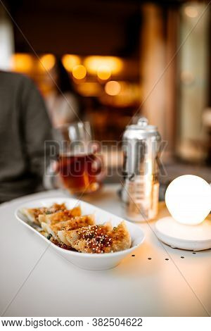 Man Drinking Beer With Gedza Dumplings On The Summer Terrace