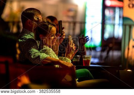 Odessa, Ukraine - Cirka 2020: Spectators At Concert In Theater Take Pictures Of Performance Of Their