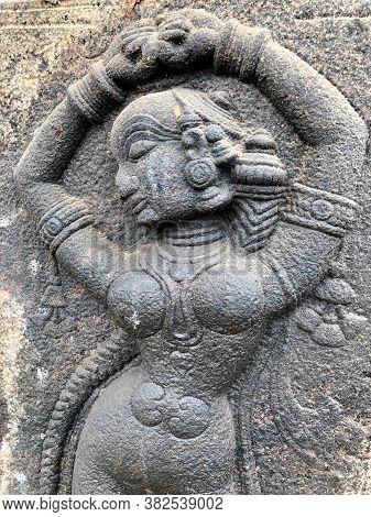 Sculpture Of Woman Posed Dance Steps. Bas Relief Sculpture Carved In The Stone Walls At Shiva Temple