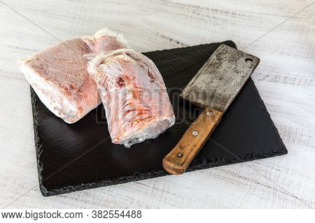 Frozen Raw Pork Neck Chops Meat Steak Isolated On Slate. Frozen Uncooked Slices Of Beef Steaks, Tend