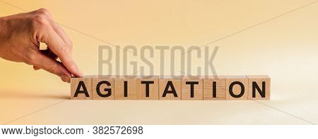 Agitation Word Made With Building Blocks. Concept.