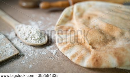 Kuboos Or Khubz - Arabic Bread On A Brown Table In The Kitchen Kitchen