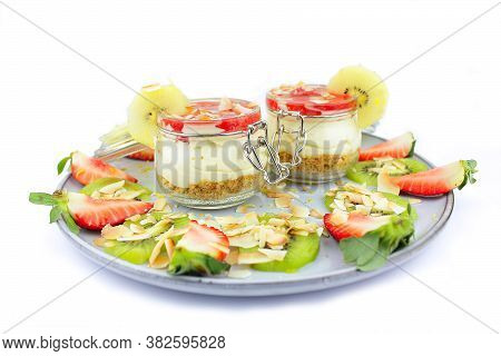 Home Made Cheese Cake With A Selection Of Fruits And Strawberry Topping.