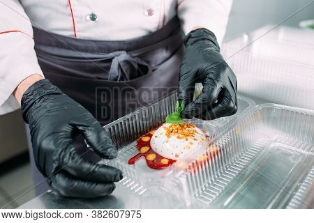 Food Delivery In The Restaurant. The Chef Prepares Food In The Restaurant And Packs It In Disposable