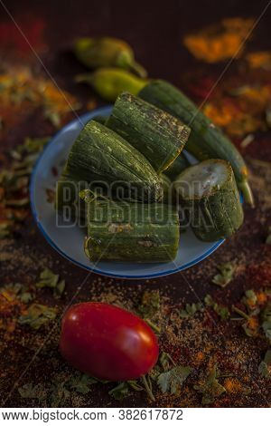 Close Up Shot Of Raw Galka Or Sponge Gourd Cut In A Glass Plate Along With All The Spices Including 