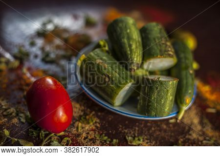 Close Up Shot Of Raw Galka Or Sponge Gourd Cut In A Glass Plate Along With All The Spices Including 