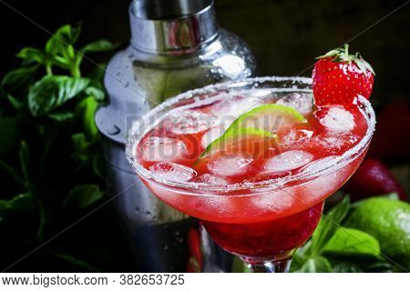 Alcoholic Cocktail With Strawberry, Lime And Ice, Black Background, Selective Focus