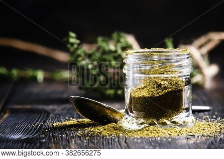 Traditional Caucasian Seasoning With Herbs And Spices, Khmeli Suneli In A Glass Jar, Black Backgroun