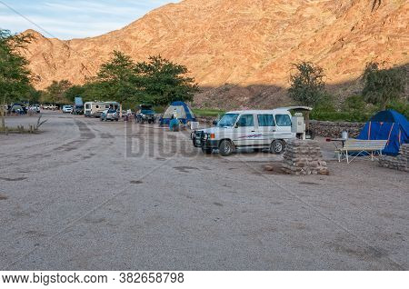 Ai-ais, Namibia - June 17, 2011: View Of The Camping Area At Ai-ais. A Caravan, Vehicles And Tents A