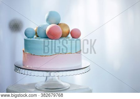 Two-tier Cake Is Two-tone, The Bottom Of The Cake Is Pink And The Top Is Blue, The Cake Has Differen