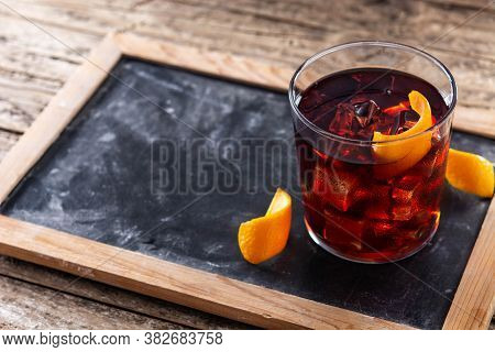Boulevardier Cocktail And Orange Zest On Wooden Background. Copy Space