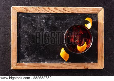 Boulevardier Cocktail And Orange Zest On Black Slate Background.top View. Copy Space