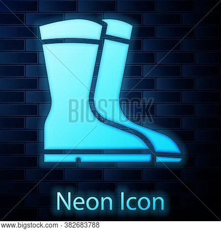 Glowing Neon Fishing Boots Icon Isolated On Brick Wall Background. Waterproof Rubber Boot. Gumboots 