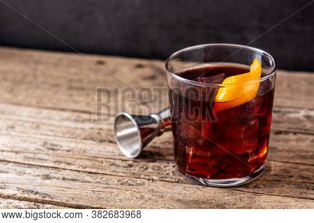 Boulevardier Cocktail And Orange Zest On Wooden Background.copy Space