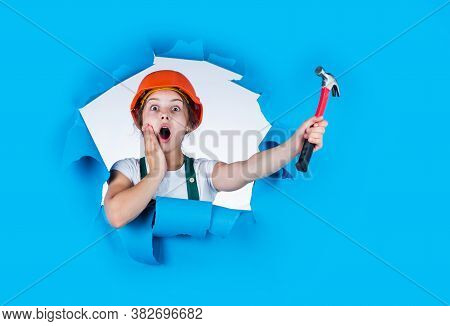 Feel The Surprise. Labor Day At 1 May. Surprised Girl In Hard Hat Holds Hammer. Best Repairer Ever. 