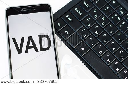 Word Vad On The Phone Screen, Lying On The Laptop Keyboard