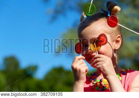 Horizontal Photo Close-up Portrait Of A Cheerful Girl In The Park. A Six-year-old Girl With A Toothl