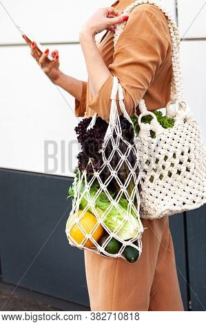 Girl Is Holding Mesh Shopping Bag With Vegetables, Greens Without Plastic Bags. Zero Waste, Plastic 