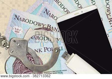 10 Polish Zloty Bills And Smartphone With Police Handcuffs. Concept Of Hackers Phishing Attacks, Ill