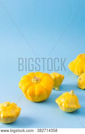 Fresh Harvest Of Zucchini And Pattypan Squash, Yellow Pattison On Blue Background