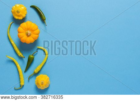 Fresh Harvest Of Zucchini, Yellow Pattisons And Peppers On A Blue Background
