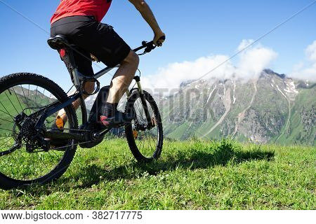 Man Riding Electric Mountain Bike Or E Bike In Alps