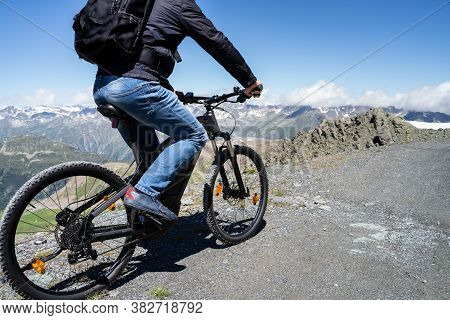 Man Riding Electric Mountain Bike Or E Bike In Alps