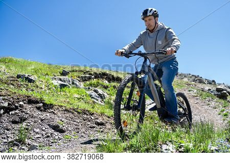 Man Riding Electric Mountain Bike Or E Bike In Alps