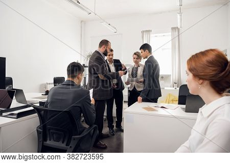 The Chief Of The Construction Company Holds A Standing Meeting With Subordinates, Gives Instructions