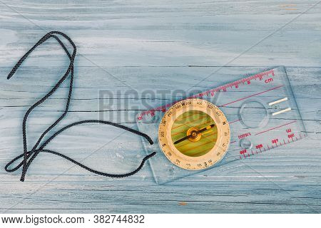 Old Transparent Plastic Sport Compass With Azimuth Measurement On Wooden Background