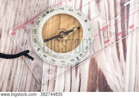 Old Transparent Plastic Sport Compass With Azimuth Measurement On Wooden Background