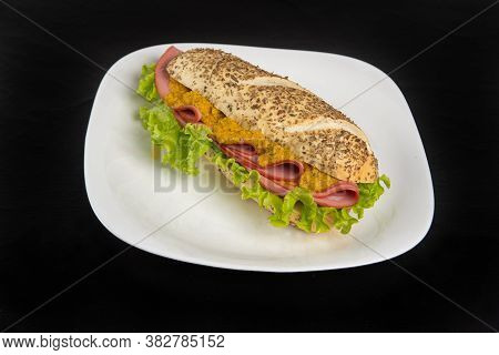 Mortadella And Lettuce Sandwich With Oregano-covered Bread, On A White Plate And Pepper Sauce And Mu