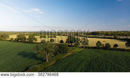 Aerial Shot Of Green Agricultural Farmers Fields Near Glastonbury, Somerset.