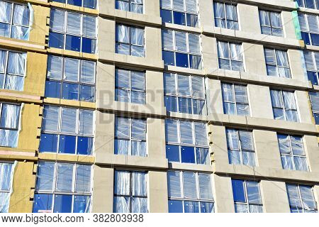 Mineral Wool And Plaster Applied On New Multi-storey Building Facade. Insulation For Thermal Protect